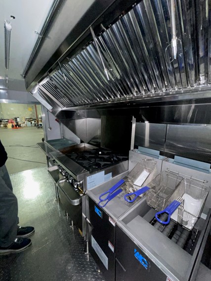 NAKS AV-100 integrated exhaust hood and fan system installed inside a food truck kitchen