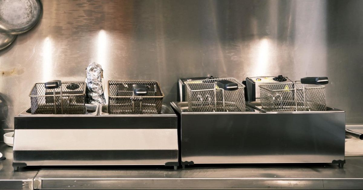 A deep fryer sits in front of a stylish